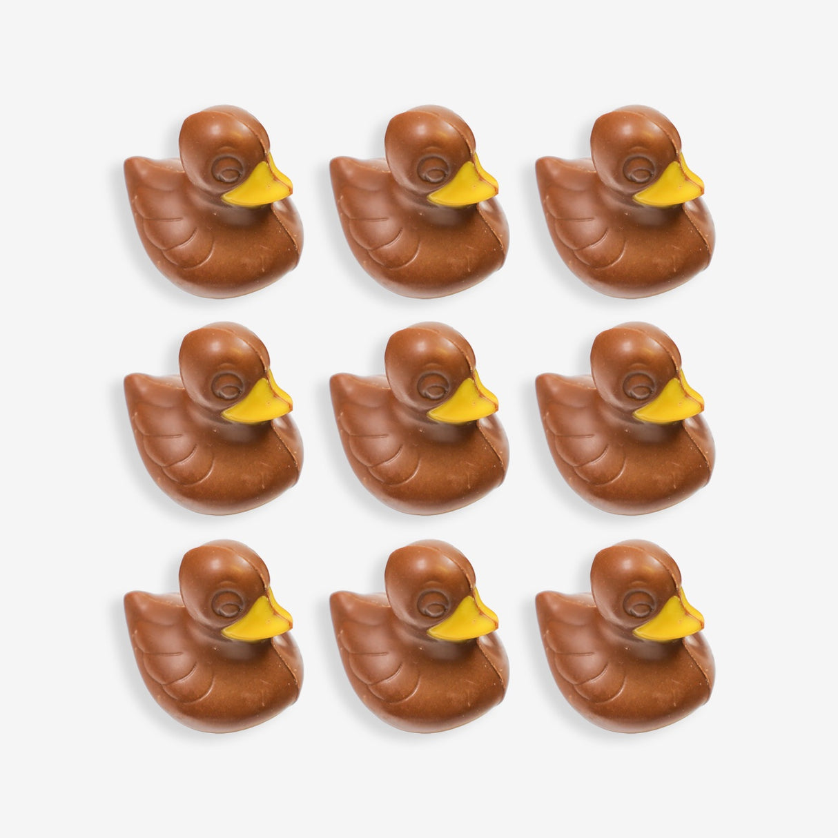 Nine chocolate ducks with yellow beaks arranged in a 3x3 grid on a white background.