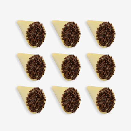 White chocolate cone with chocolate sprinkles on a white background