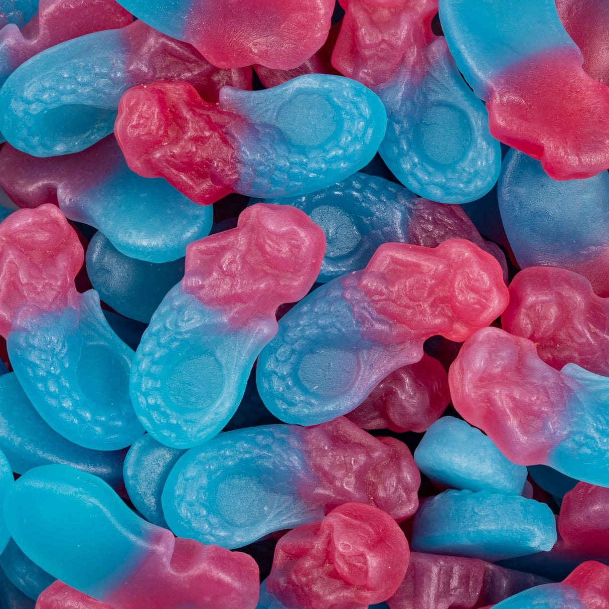 Close-up of pink and blue gummy mermaids.