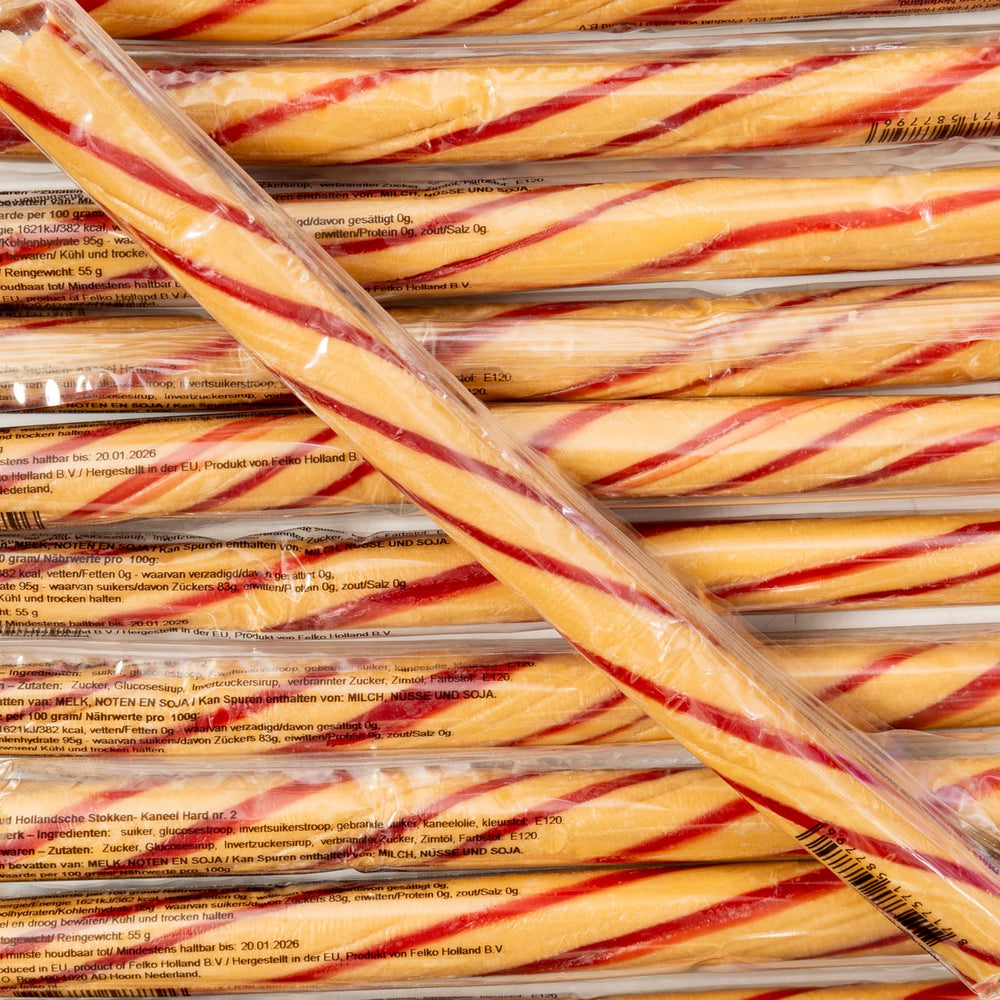 Stack of red and yellow striped candy canes in clear packaging.