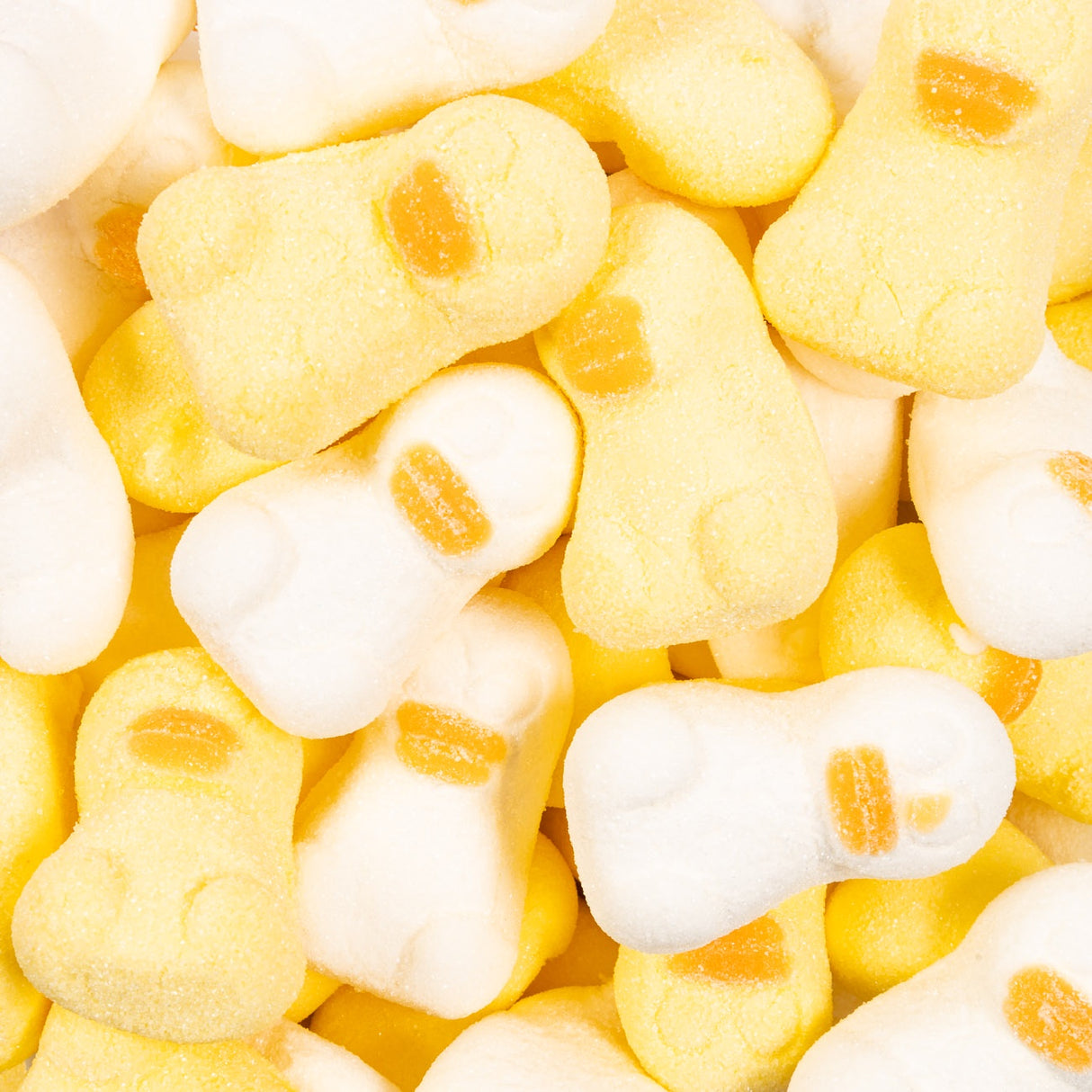Close-up of yellow and white candy shaped like ducks