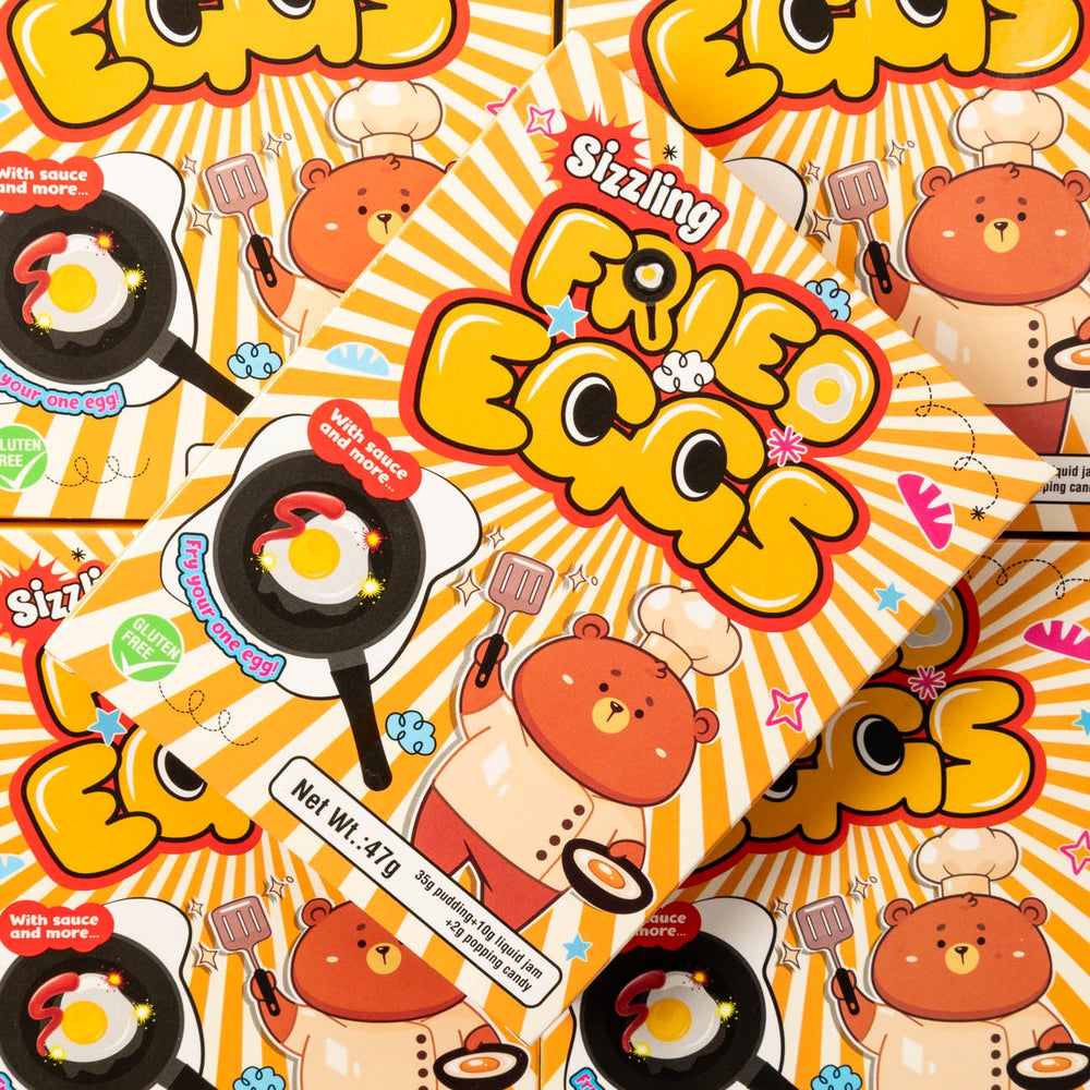 Cartoon packaging design of 'Sizzling Fried Eggs' with bears and frying pans on a bright background.