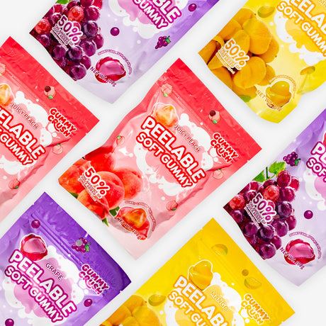Assorted packages of peelable soft gummies in different flavors on a white background