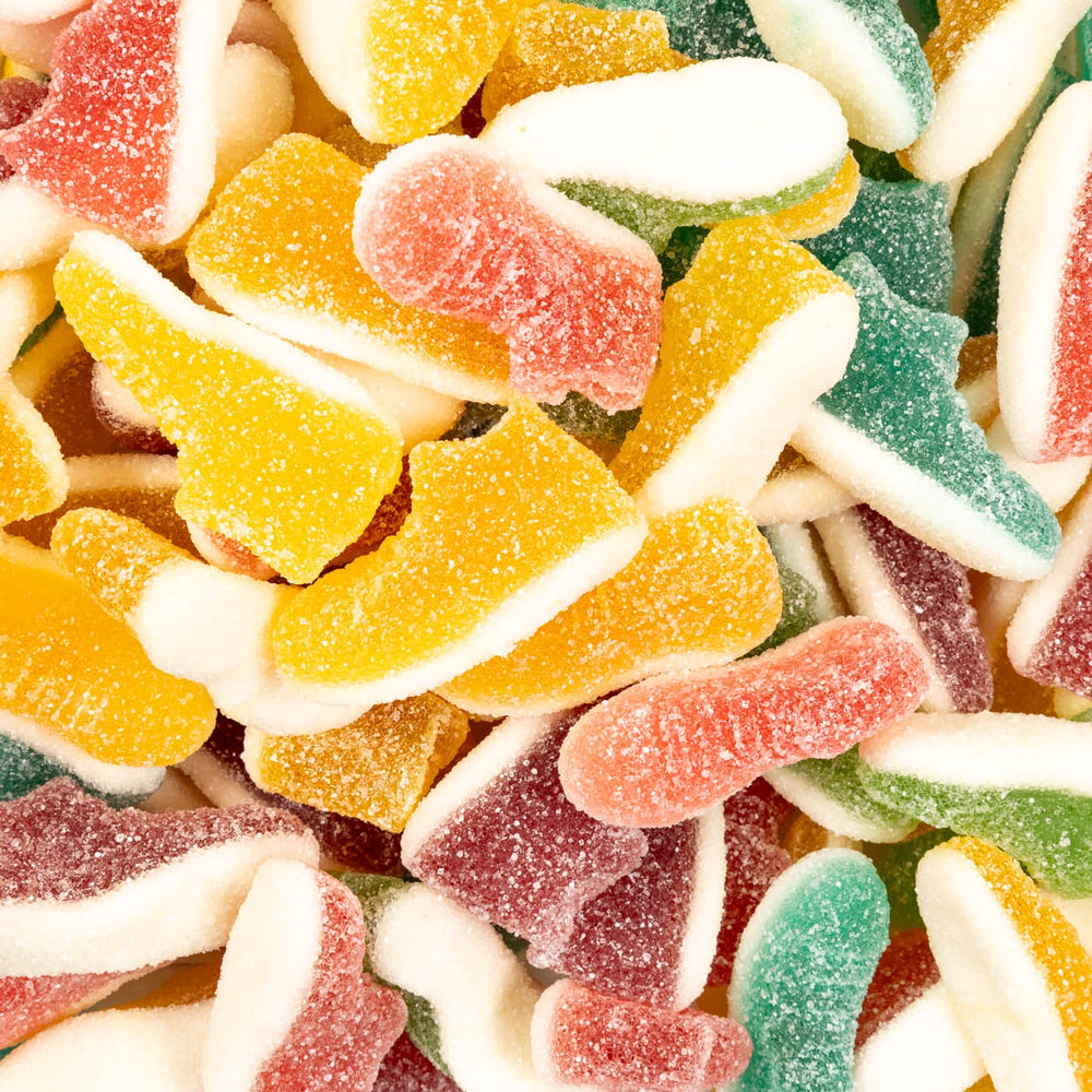 Assorted colorful gummy candy pieces on a white background