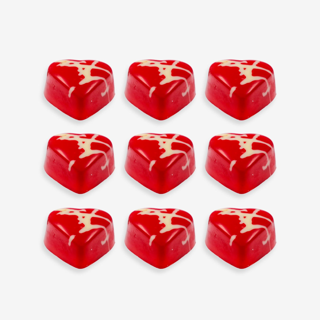 Red heart-shaped candies with white swirl patterns on a white background